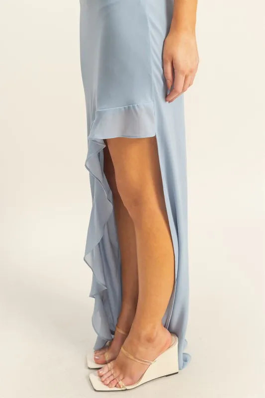 Close up of blue chiffon maxi dress with cascading ruffle trim along high low hem
