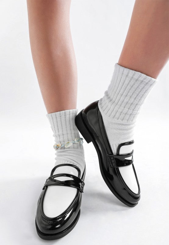 Black and white shoes with white socks on a white background