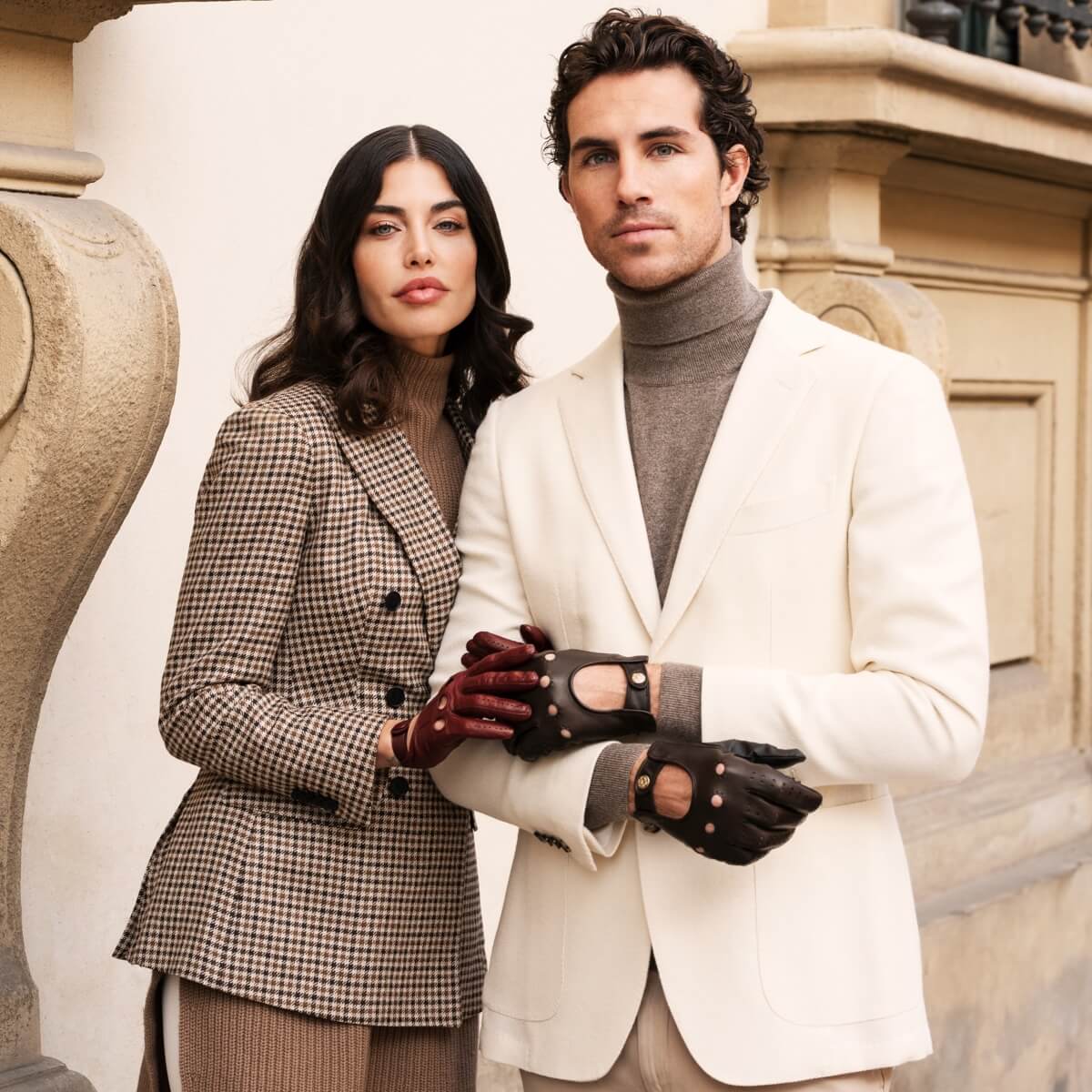 Man and woman in formal attire standing together outdoors.