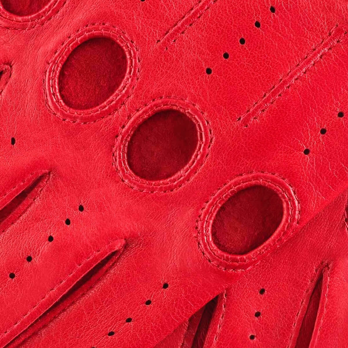 Close-up of red leather glove with perforated design