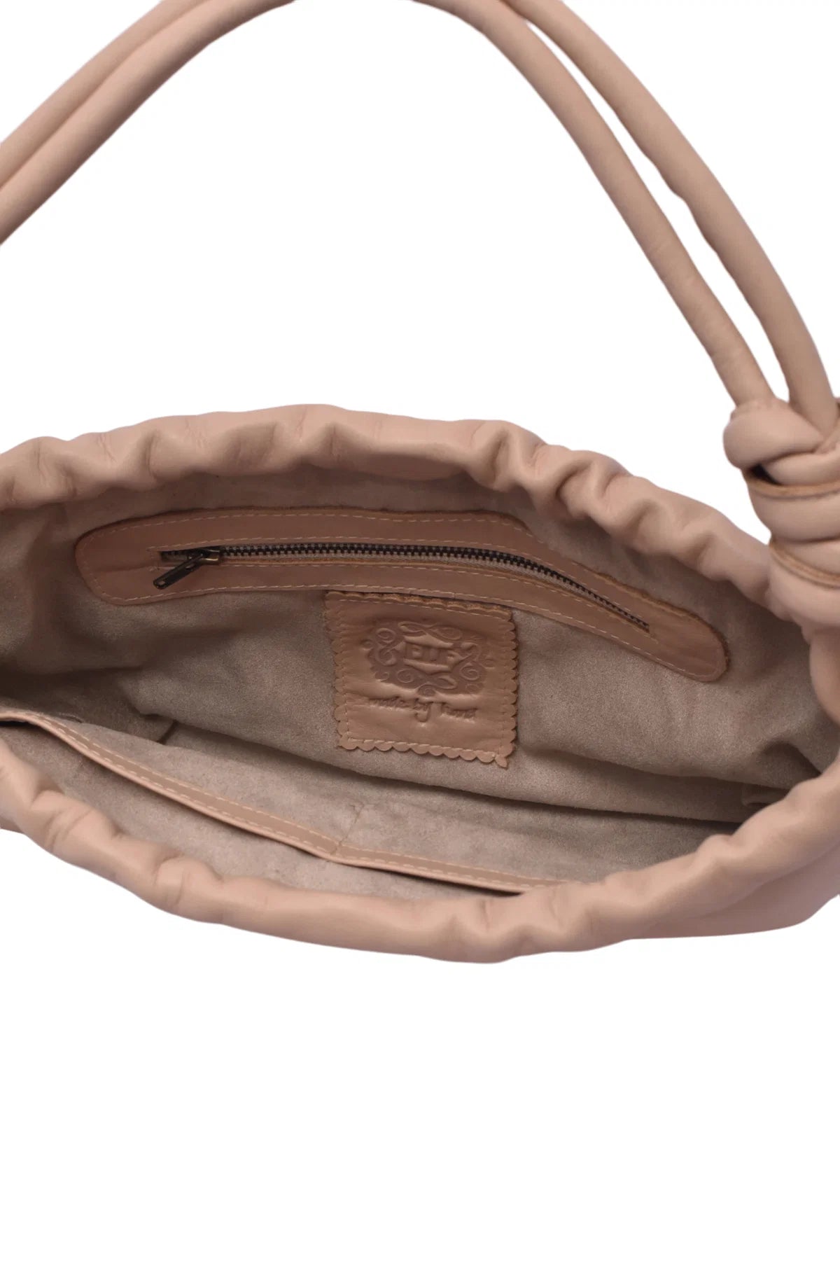 Close-up of a beige interior handbag with a visible brand logo on a white background