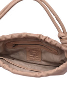 Close-up of a beige interior handbag with a visible brand logo on a white background