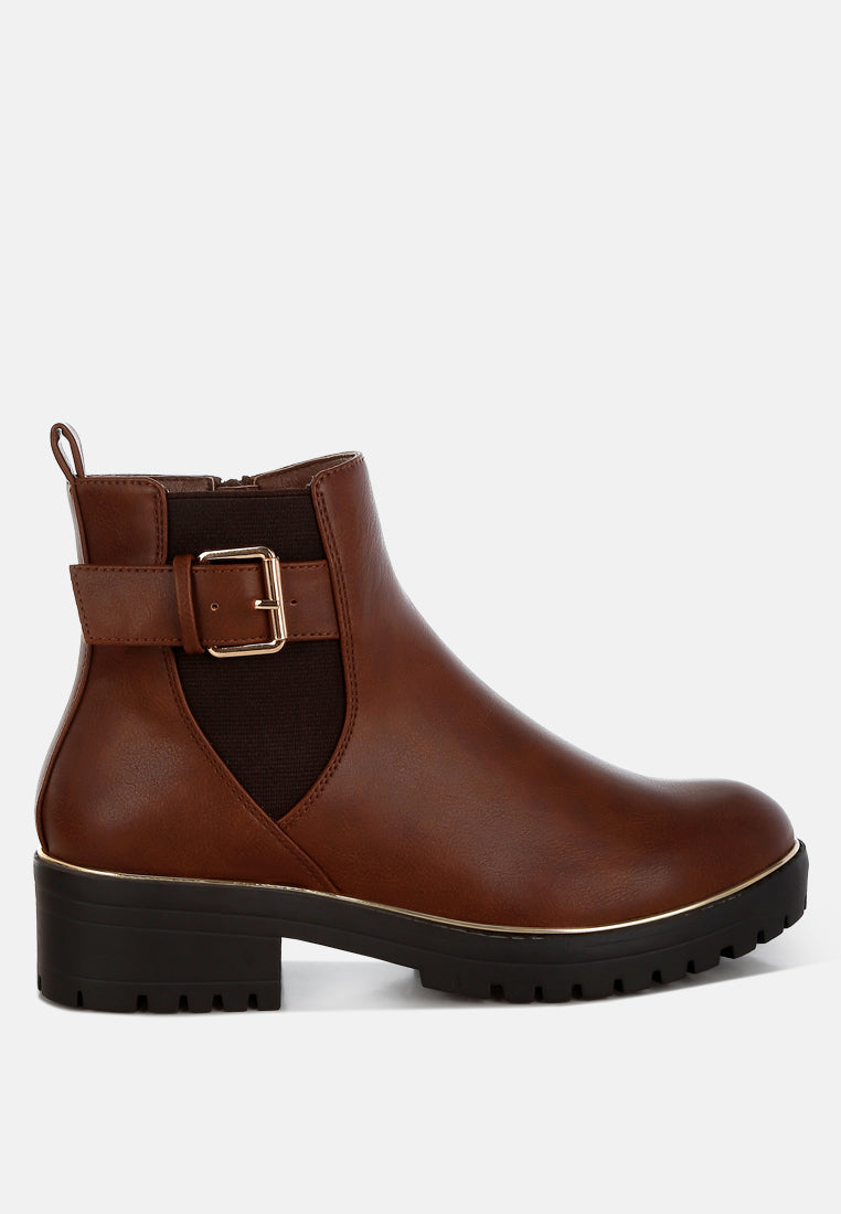 Brown ankle boot with a buckle on a white background