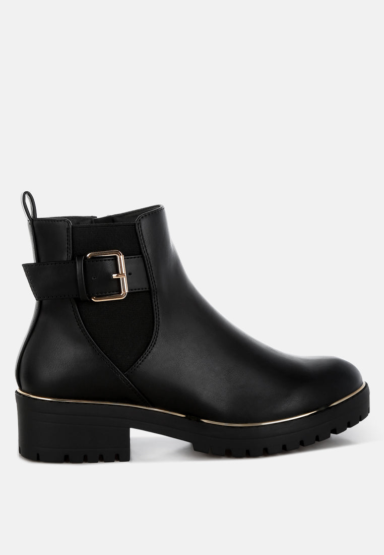 Black rain boot with a gold buckle on a white background