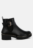 Black rain boot with a gold buckle on a white background