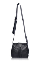 A black leather handbag with fringe details and wide crossbody strap on a white background, front view