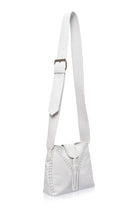 A white leather shoulder bag with a long strap, a front flap, and a tassel detail, shown on a plain white background.