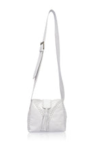 White leather handbag with fringe details and wide crossbody strap on a white background, front view