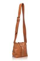 Tan leather handbag with a strap on a white background