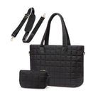 Black quilted travel tote with matching pouch on a white background