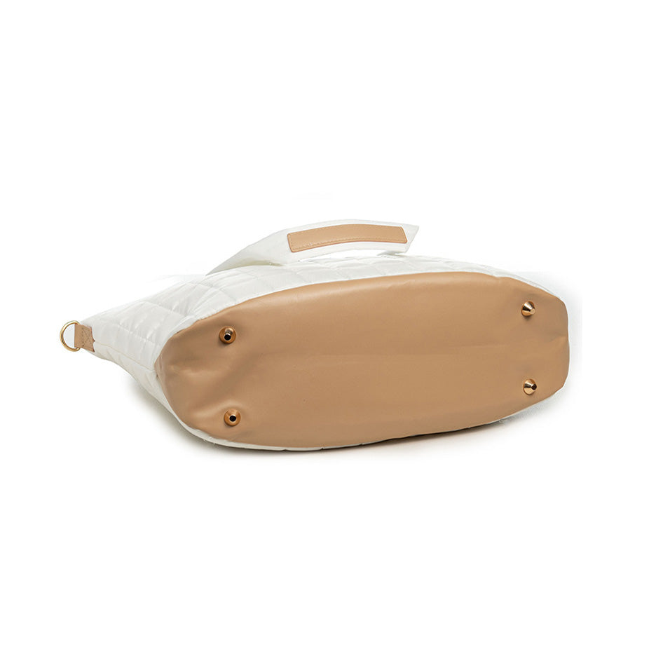 Close-up of a white shoe with a tan sole on a white background