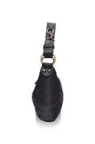 A black leather platform handbag shown from a rear three-quarter view, featuring a thick black platform sole, a wide shoulder strap, and a prominent gold-tone metal O-ring with a hook clasp.