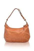 Tan leather handbag on a white background