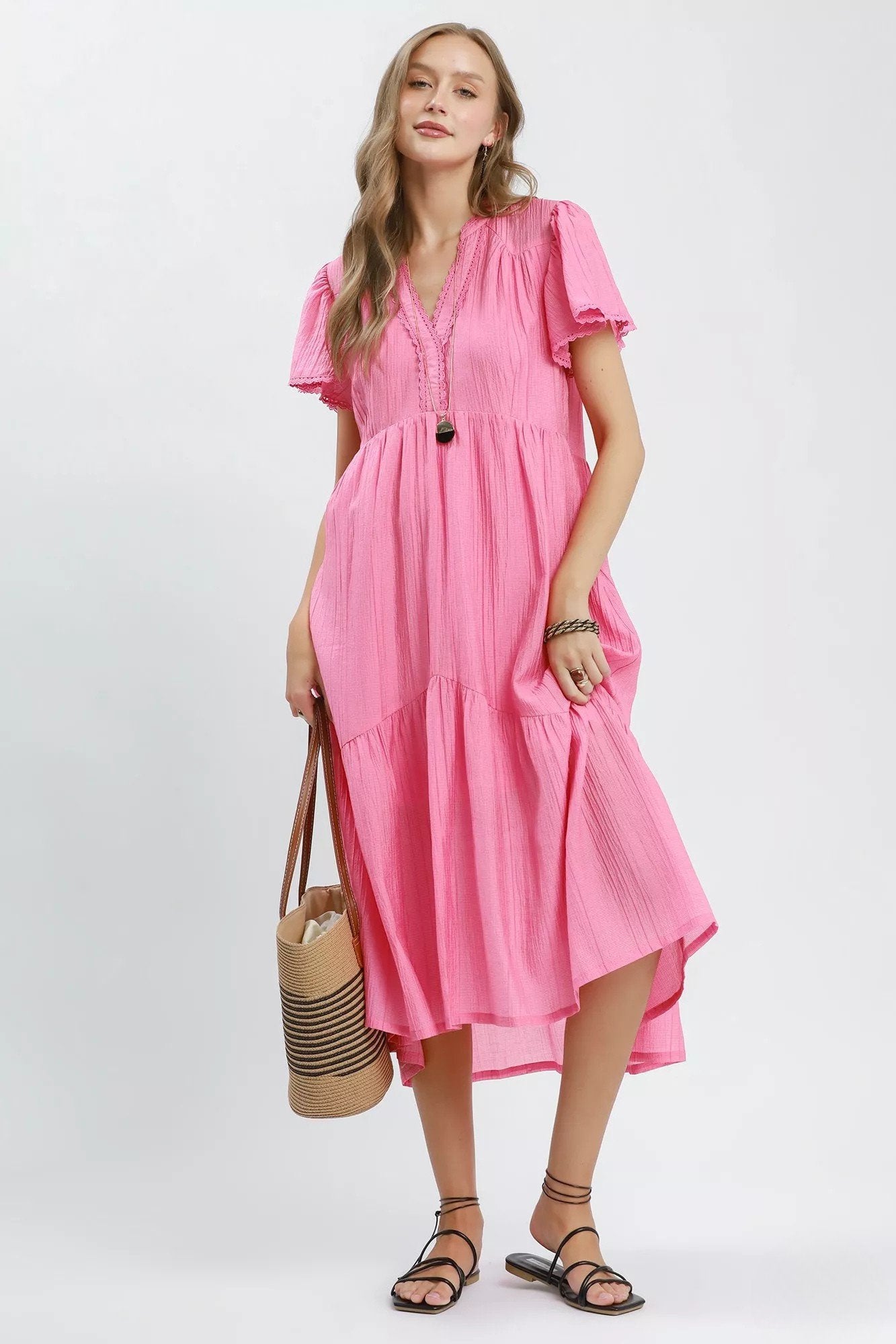 Midi Dress in bubblegum pink gauze with flutter sleeves, lace trimmed V neckline, side pockets, and relaxed tiered midi silhouette.