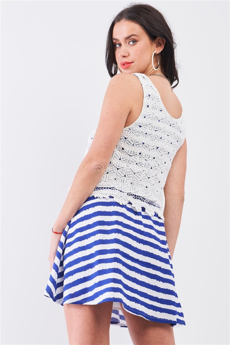 Back view of blue and white stripe swing dress with white crochet overlay detail
