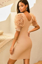 Back view of taupe ribbed bodycon dress with deep scoop back and rosette sleeves.
