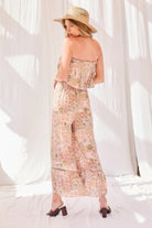 Back view of blush strapless rayon jumpsuit with floral and geometric print details