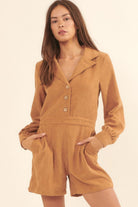 Model wearing a tan corduroy long sleeve romper with button-front detail, collared neckline, and side pockets-AVAH