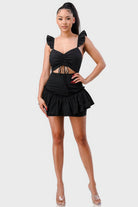 Full body view of black sleeveless mini dress with flutter straps and fitted silhouette
