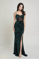 Full front view of emerald green sequin formal gown with mesh bodice and thigh-high slit