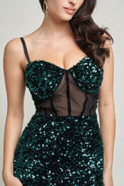 Detailed close-up of sequin cups and mesh corset paneling on emerald gown