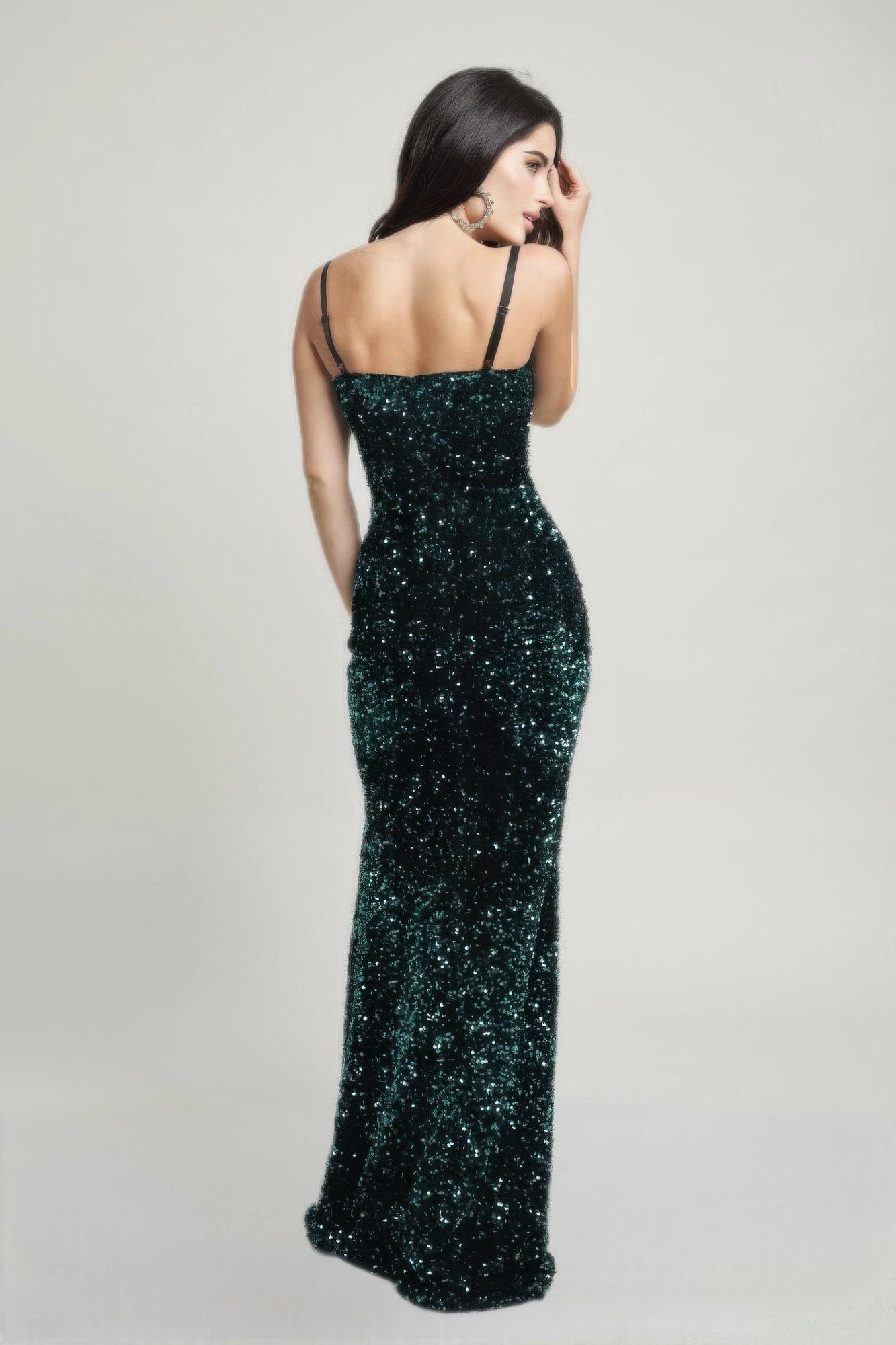 Back view of emerald green sequin gown with straight back and floor-length skirt