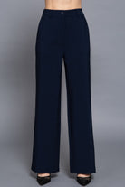 Front view of navy straight-leg pants with flat front and button closure
