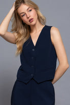 Model wearing navy tailored vest, close-up view of V-neck and button detail-AVAH