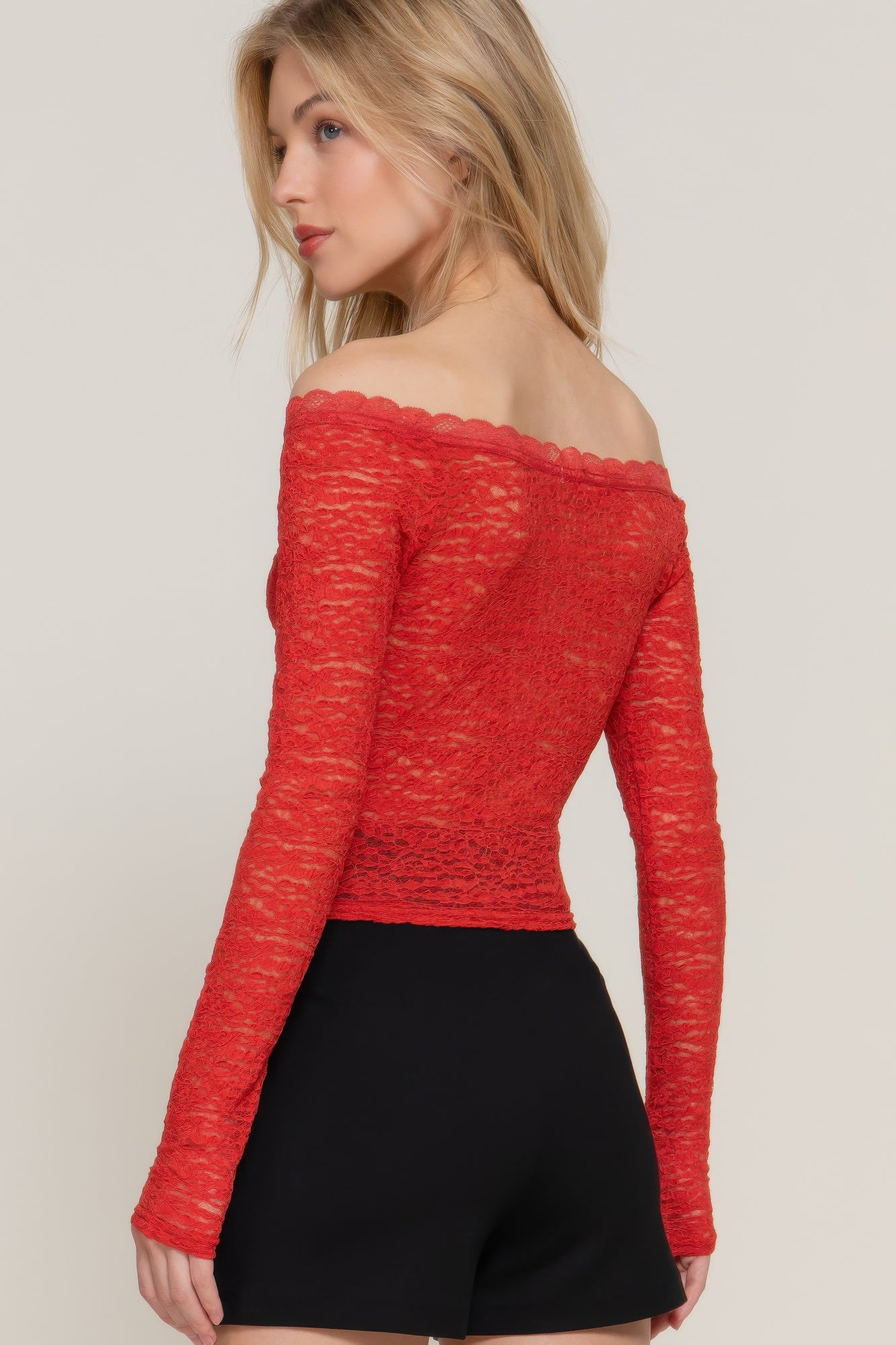 Back view of red off-shoulder lace long sleeve top.