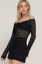Close-up of black lace off-shoulder top with ruched bust detail