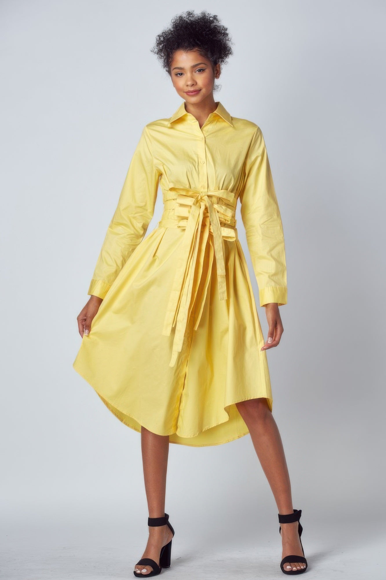 Yellow cotton shirt dress with corset inspired waist tie detail and high-low midi hem front view