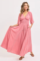 Model showcasing flowy maxi skirt and pockets of pink dress-AVAH