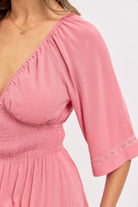 showcasing lace trim detailing of maxi dress