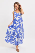 Model in blue floral tiered maxi dress walking 