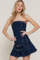 Front view of dark wash strapless denim mini dress with buckle details
