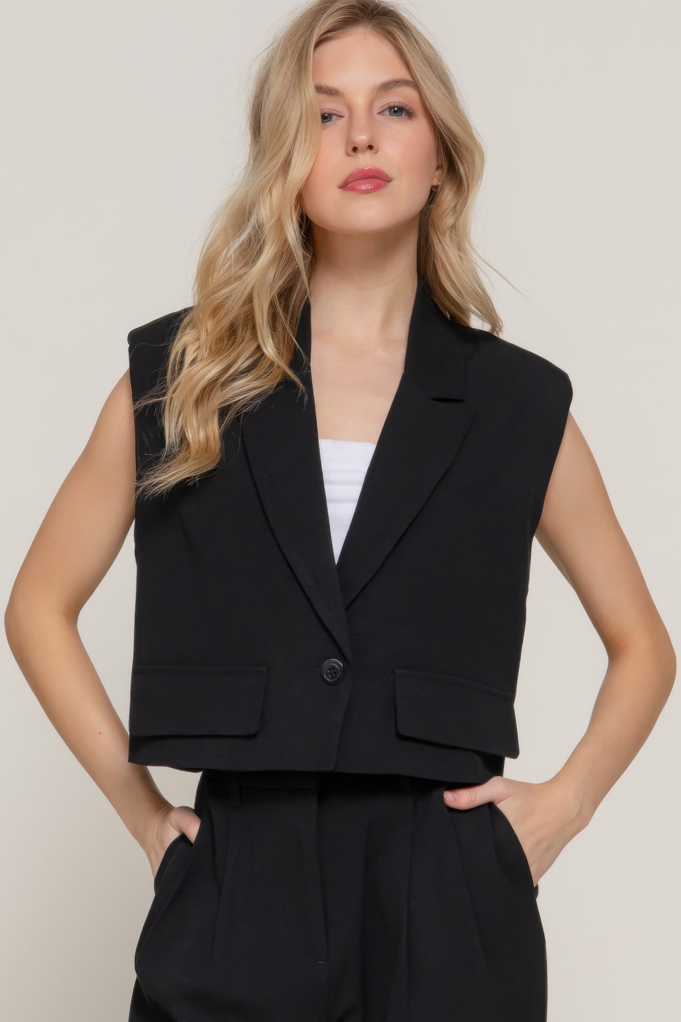Model wearing a black lapel collared vest-AVAH
