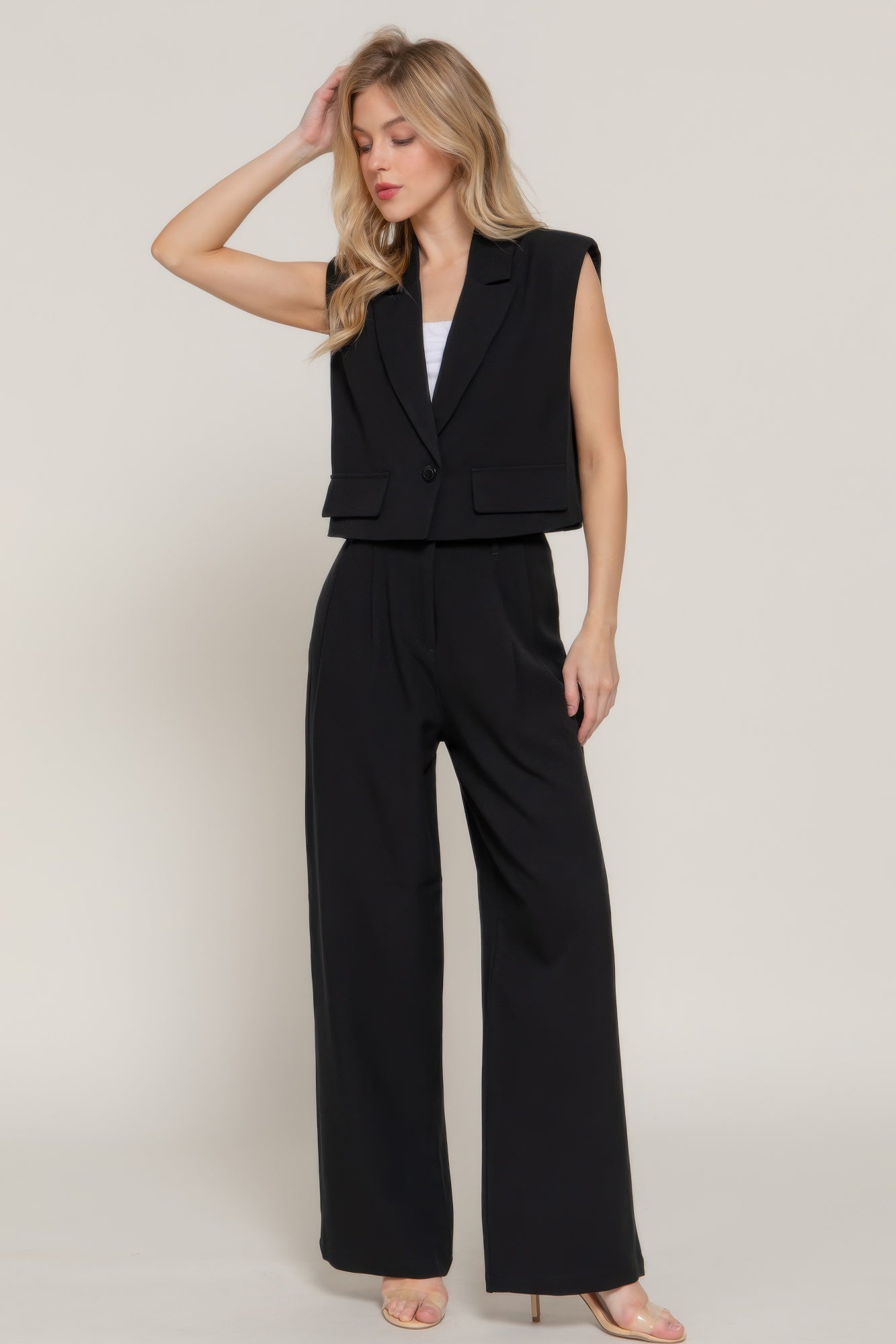 AVAH black collared vest styled with black trousers and nude heels for a chic sophisticated look.