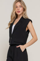 Side view of model wearing a lapel collar vest showcasing flap pocket detail