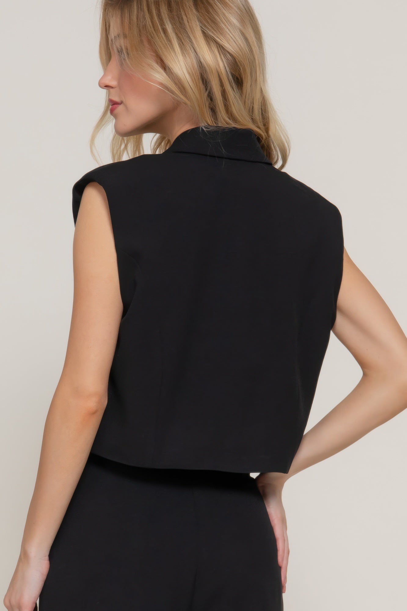 Back view of collared vest with cropped silhouette 