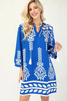 Woman wearing cobalt blue printed tassel mini dress
