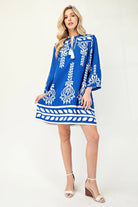 Front view of blue and ivory boho shift dress with tassel ties
