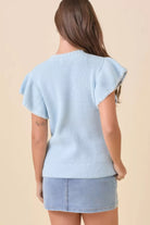 Back view of baby-blue knit sweater with flutter sleeves and ribbed trim