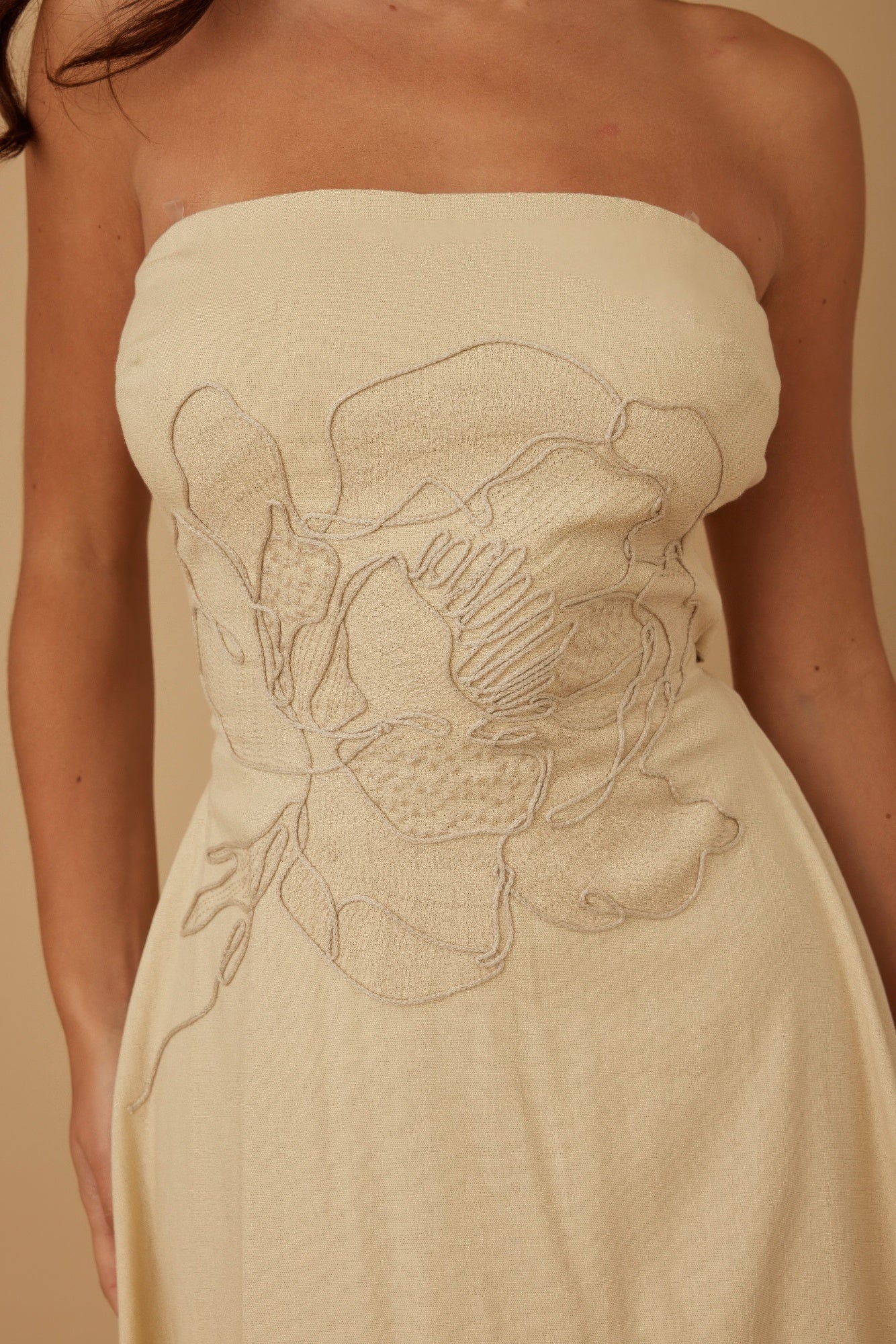 Close-up of floral embroidery detailing at the front bodice
