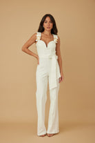 Main Event White Wide Leg Jumpsuit with sweetheart bustier bodice and gold hardware ruffle straps front view, AVAH