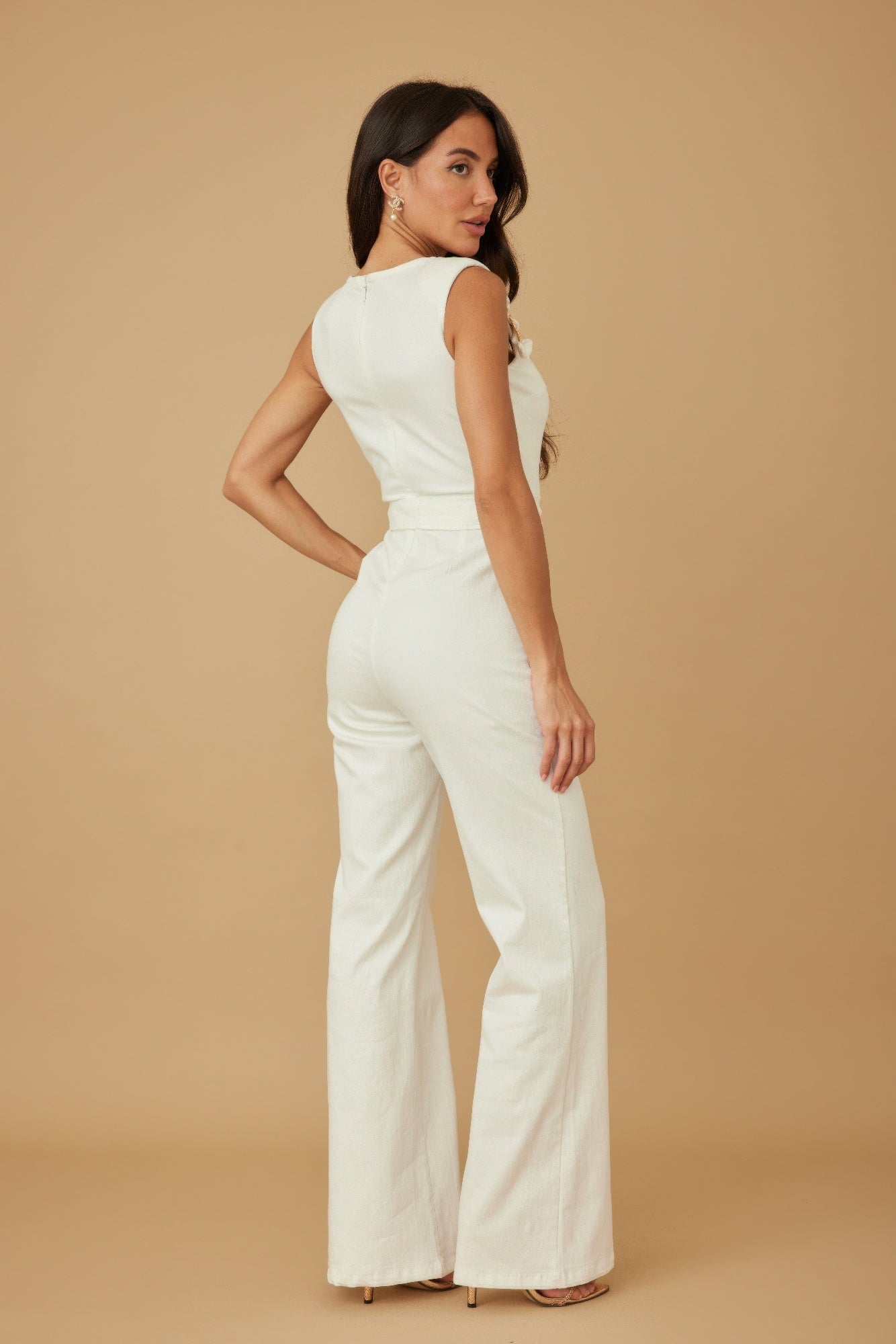 Back three quarter view of white wide leg jumpsuit showing tailored trouser and tie waist, AVAH