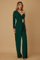 Side view of emerald one-shoulder jumpsuit highlighting crystal strap detail

