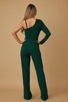 Back view of emerald green one-shoulder jumpsuit with fitted waist and zipper closure
