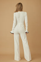 Back view of ivory wide-leg jumpsuit with fitted waist

