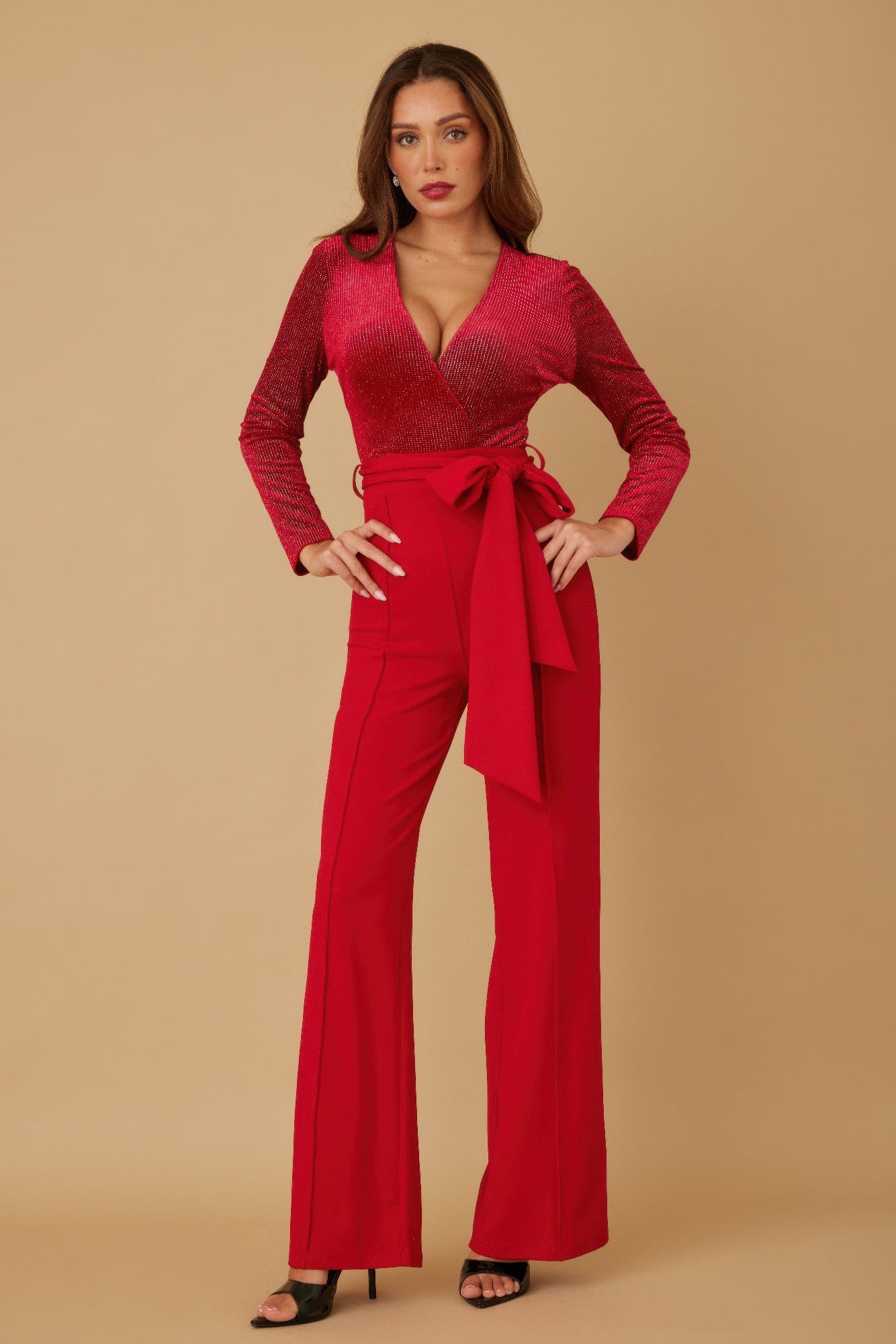 Front view of red wide leg jumpsuit with deep V neckline
