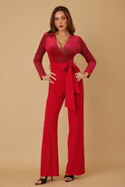 Front view of red wide leg jumpsuit with deep V neckline
